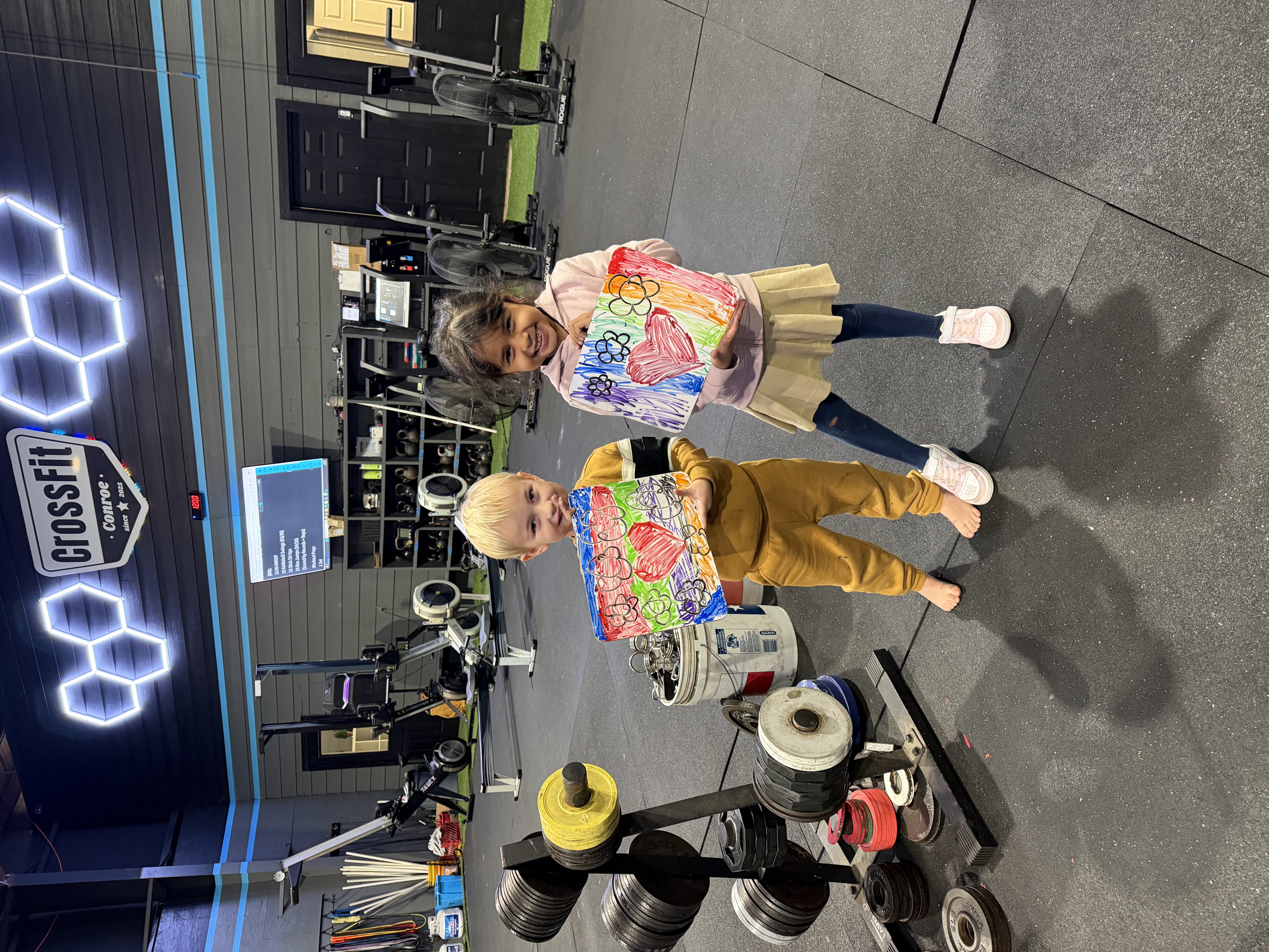 Kids at CrossFit Conroe showing their artwork